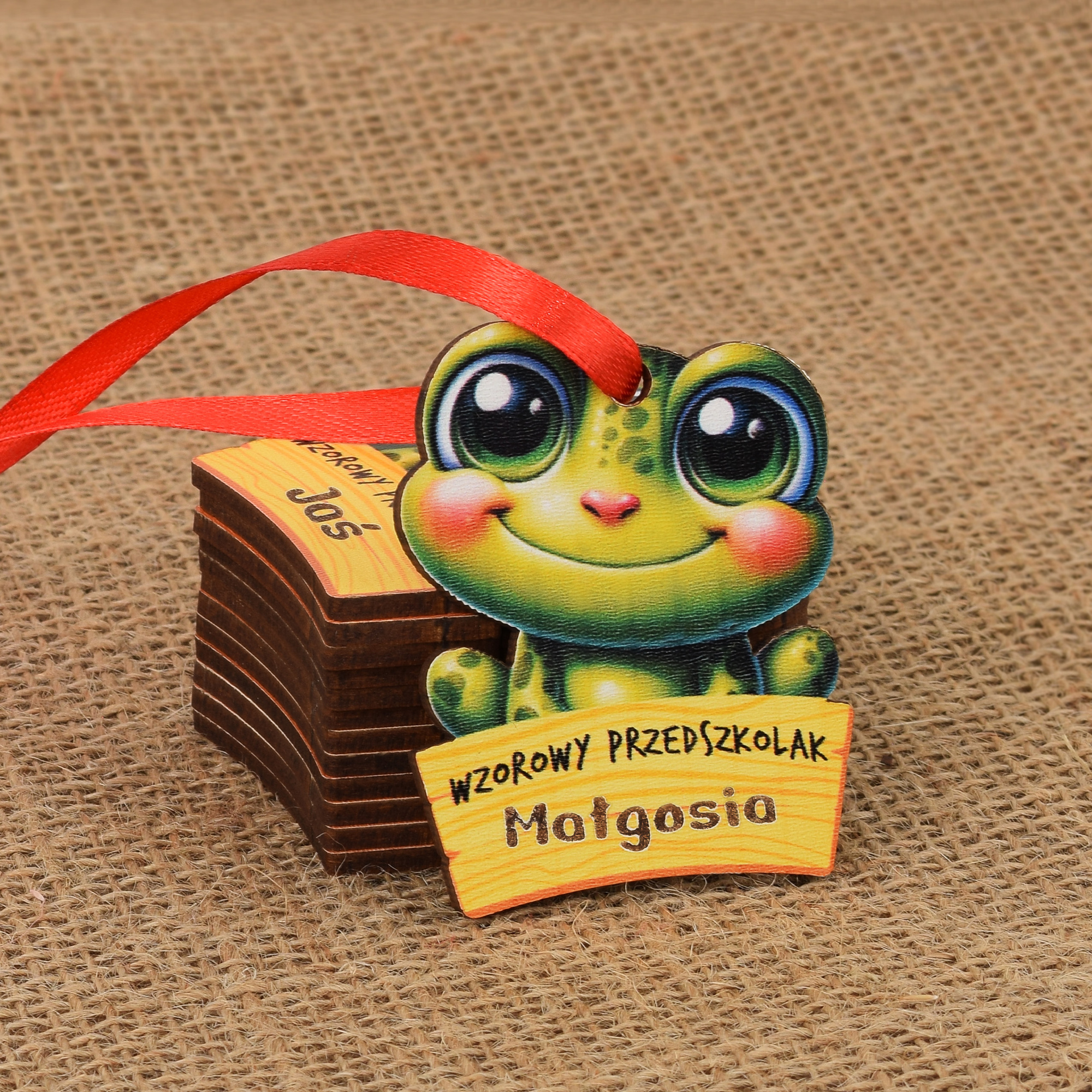 Medal w kształcie żaby, żabki
